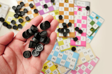 a child plays with bingo pieces,close-up a hand holds bingo pieces,