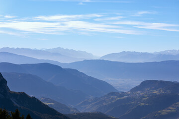 Mountain ranges of Val Gardena covered with morning haze. Seiser Alm (Alpe di Siusi) South Tyrol, Italy