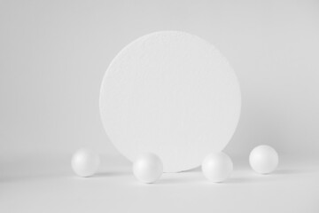 Round 3d stand surrounded by randomly scattered balls. Concept of geometric composition on white isolated background