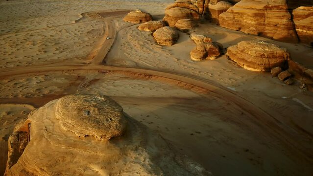Aerial Panning A Large Desert Rock Formation And The Top Of A Tomb Entrance - Hegra, Saudi Arabia