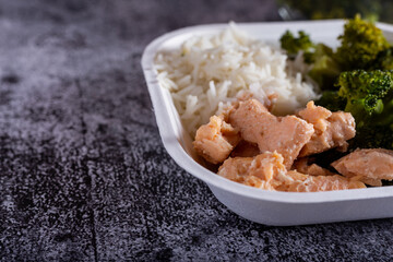 Bowl with salmon, basmati rice and broccoli.