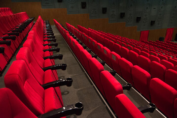 An empty cinema room with red velvet seats. Empty cinema.	