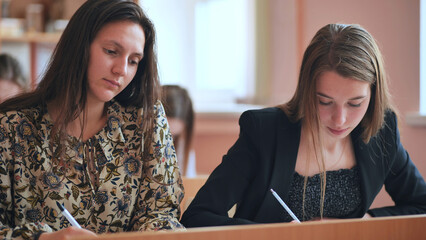 Pupils of the 11th grade in the class at the desks during the lesson. Russian school.