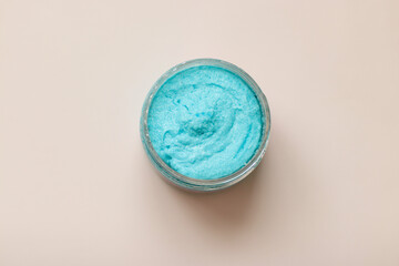 Shower scrub care for women on a plain background close-up. Spa treatments for the body bubble gum. Content filming of products.
