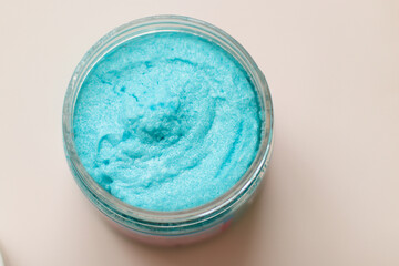 Shower scrub care for women on a plain background close-up. Spa treatments for the body bubble gum. Content filming of products.