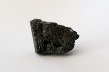 Macro shooting of raw Jet stone isolated on white background. raw gem stone. There is noise and...