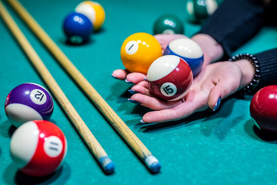 You Can See Hands In  Deftly Holding A Cue And Trying To Drive A Billiard Layer Into The Hole.