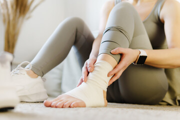 Sport injury leg pain - woman hurting holding painful sprained ankle muscle. - obrazy, fototapety, plakaty