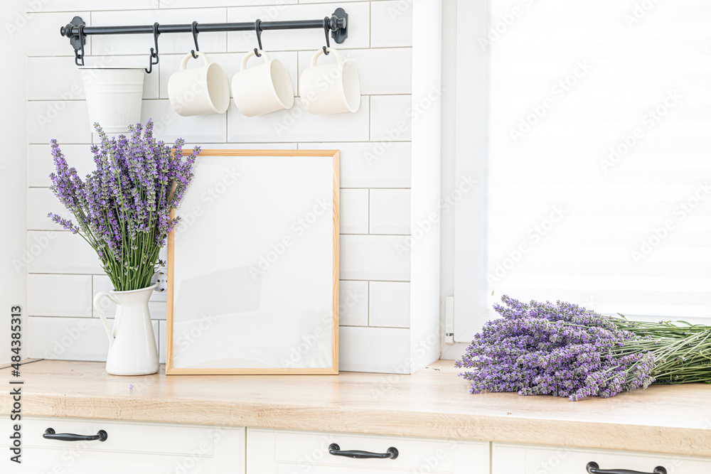 Wall mural A bouquet of lavender in the interior of a stylish kitchen. Vertical frame mockup on a wooden table.