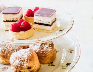 A Cake Stand Full Of Fancy Cakes For An English Afternoon Tea