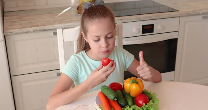 the child eats vegetables with pleasure. The girl eats healthy food. the concept of children's health