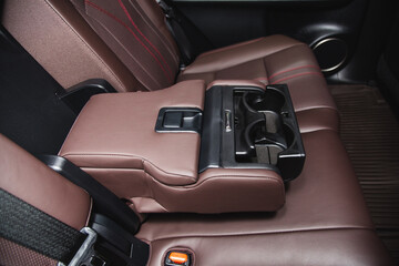Fototapeta na wymiar Luxury car rear seat cup holders with control panel