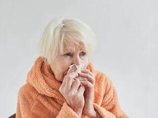 senior ill woman freezing cold at home. Health care, crisis, oldness concept