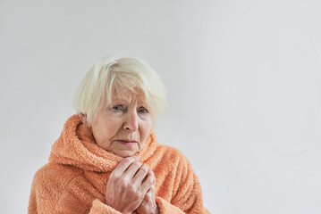 senior ill woman freezing cold at home. Health care, crisis, oldness concept
