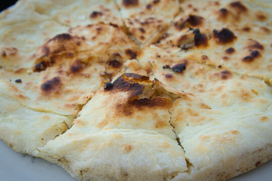 Traditional Croatian rustic bread - close up of a flatbread pita with salt, garlic and olive oil