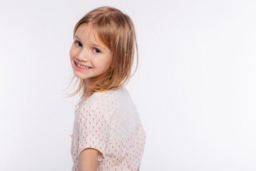 Portrait of a happy smiling child girl. Cute 6 years old girl Isolated over white background
