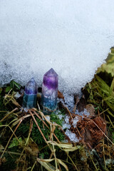 Crystal gemstones on moss and snow, natural winter background. Minerals for esoteric Crystal...