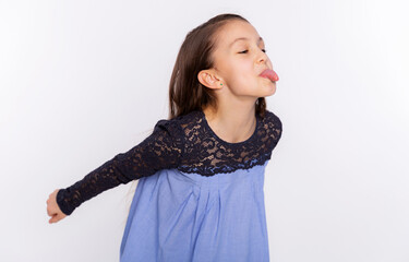 Kid funny girl fooling around teases and shows tongue isolated on white background. Face expression