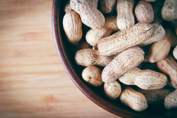 Peanut closeup top view on wooden background closeup