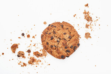 Stack of chocolate chip cookies and crumbs on white background. Top view.