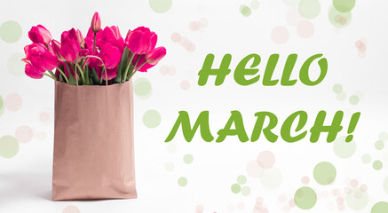 Pink tulips in a craft bag on a white background with text Hello March.