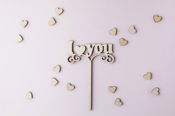Fototapeta premium A wooden axe with the words I LOVE YOU on a pink background. 