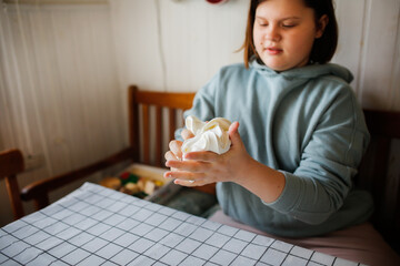 Children play with modeling mass, make slime from starch and hair balm. Children's experiences and experiments at home. Children in the kitchen kneading dough