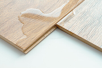 Laminate and water. Wooden floors are impervious to moisture.