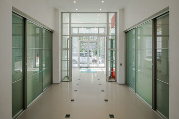 Modern interior of hall in luxury private house. Glass sliding doors.