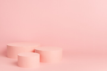 Elegant set of three pastel pink circle podiums mockup on soft light background, copy space. Template scene for advertising, presentation cosmetic product or goods, design.
