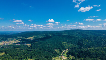 Obraz premium mountains aerial view in blue sky clouds