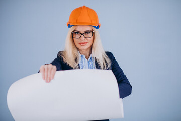 Mature woman architect in hardhat isolated in studio