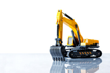 Big yellow toy excavator on a light background with reflection. The concept of construction and land works. Free space for an inscription