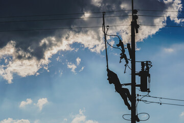 The silhouette of power lineman replacing a transformer and hotline clamp, bail  clamp. Using clamp...