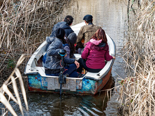 visitor in oasi massaciuccoli during bird watching on top a boat