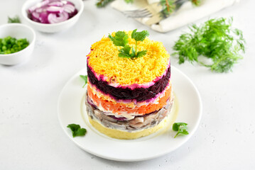 Layered salad with beet, herring, carrots and potatoes