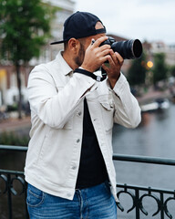 Photographer taking photos in the canals of Amsterdam in the Netherlands