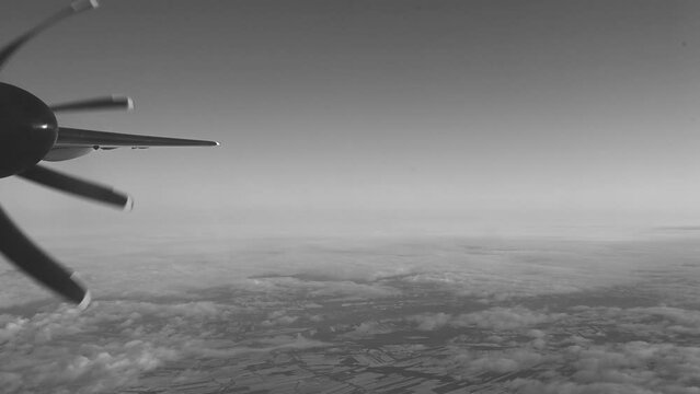 Propeller Airplane Engine Spins Over The Slightly Clouded Horizon Of A Rural Area. 