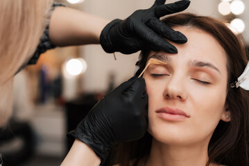 The cosmetologist-brovist corrects and gives shape, plucks out excess hairs in the eyebrows with...