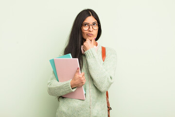 young pretty hispanic woman thinking, feeling doubtful and confused. student concept