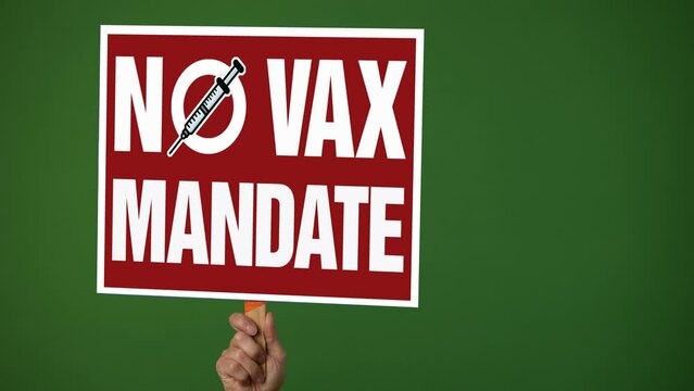 Hand Holding Sign Banner With Text No VAX Mandate In Protest Of Covid 19 Vaccine Stop Immunization No Tax Concept On Green Screen Background.