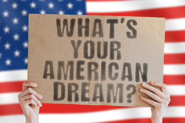 The question " What’s your American dream? " on a banner in men's hand with blurred sea on the background. Moving. Motive. Motivating. Process. Workplace. Study. Employment. Work. Route. Guidance