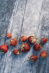 Fresh red strawberries on a wooden surface.