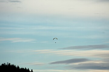 Paraglider enjoying a snowy sunset