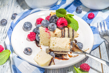 Classic cheesecake with chocolate topping and fresh berries, homemade cheesecake for summer breakfast 