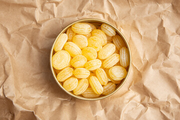 Lemon lollipops in an iron box on kraft paper