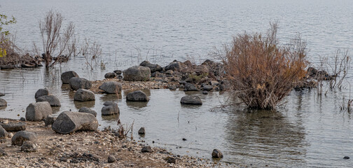 Rocks in the Sea of Galilee as seen from the trail along the western coast of Lake Kinneret, Galilee, Israel