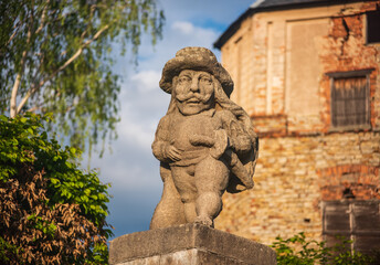 Fototapeta na wymiar Baroque stony figure of the Dwarf Cabinet near Castle of Nove Mesto nad Metuji, Czech Republic.