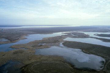 Fototapeta na wymiar steppe plain landscape lake in the middle of fields