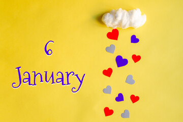 6 january day of month, colorful hearts rain from a white cotton cloud on a yellow background. Valentine's day, love and wedding concept